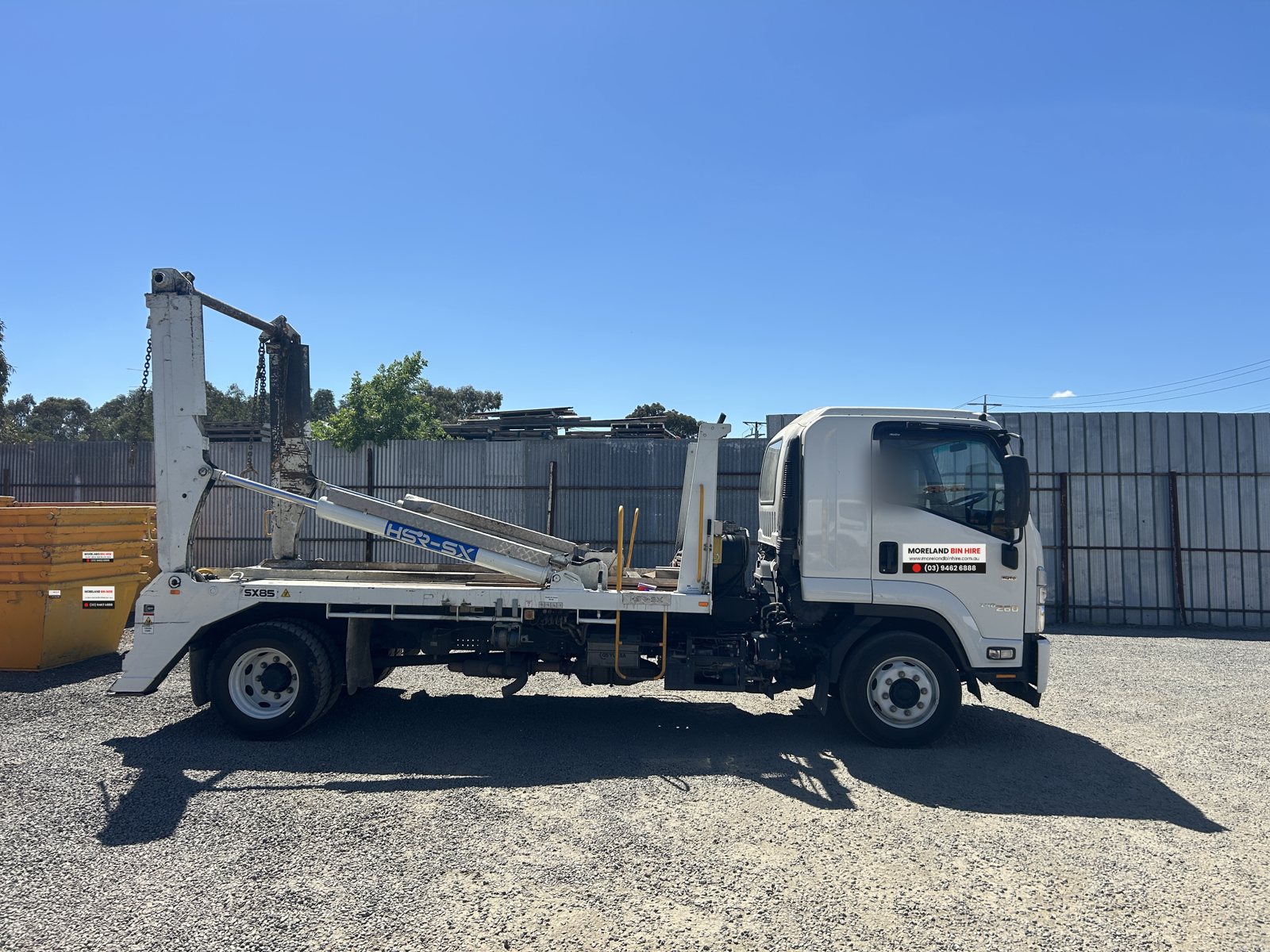 Isuzu FSR skip loader truck, side view